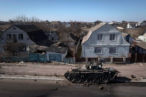 Destroyed tank sits on a street north of Kyiv