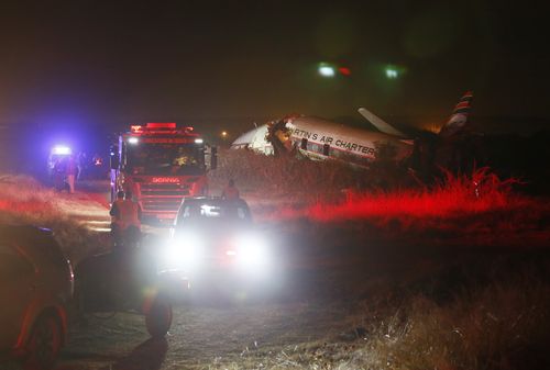 A charter plane lays in a field in Pretoria, South Africa, Tuesday July 10, 2018. The plane crashed killing one person and injuring 20 others with injuries ranging from minor to critical, according to Russel Meiring, a spokesman for paramedic company ER24. (AP Photo/Phil Magakoe) 