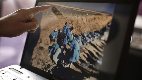 In this May 17, 2016 photo, Sirwan Jalal, Director of Mass Graves for the Kurdish Regional Government, points to an image of the site of a mass grave. UN investigators said today they have verified the location of more than 200 mass grave sites from the time of the Islamic State groups reign in northern Iraq, containing the bodies of between 6,000 and 12,000 victims.