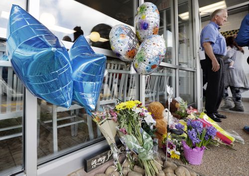 Tributes for the victims outside the store. (AP/AAP)