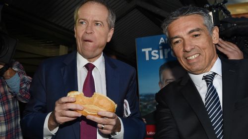Leader of the Opposition Bill Shorten and Labor candidate for Reid Angelo Tsirekas eat sausage sandwiches at Strathfield North Public School polling booth. (AAP)
