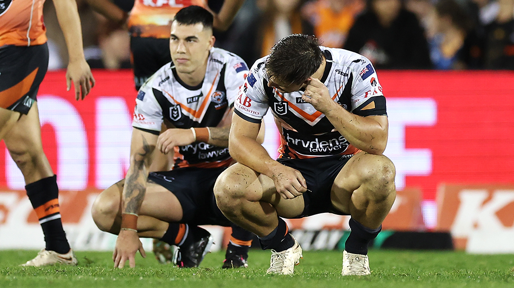 The Wests Tigers looks dejected as the Sea Eagles celebrate victory during their round eight NRL match. 