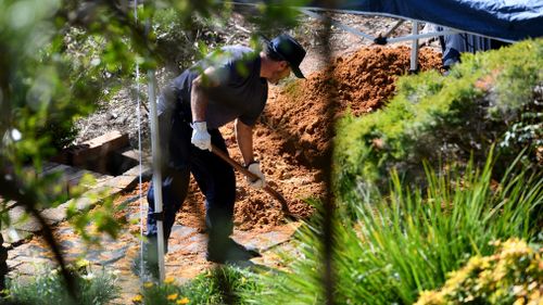 Police dig at the former Dawson home today.