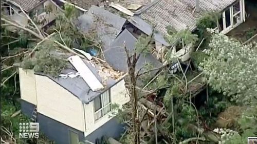 A house in Melbourne's outer east was one of many crushed by a tree felled during a storm in Victoria.