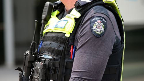 Members of Victoria Police attend a protest in Melbourne. Generic police officers uniform badge logo. Photo by Paul Rovere