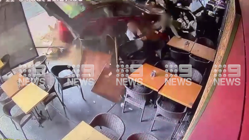 C﻿CTV footage has shown the moment a car has smashed into a busy cafe in Sydney's west, injuring several people and sending tables and chairs flying. Emergency services were called to Bankstown's Coffee Emporium on North Terrace at 11.30am Saturday after a red Honda Accord with red P-plates crashed into the outdoor area of the coffee shop.