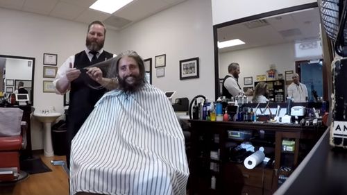 Off comes the beard and long hair, in a mission to look "business-like". Source: YouTube