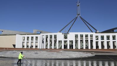 A cleaner working on the forecourt of Parliament House in Canberra.