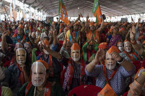 India election: Bharatiya Janata Party (BJP) supporters wear masks of Indian Prime Minister Narendra Modi during an election rally addressed by him in Meerut, India.
