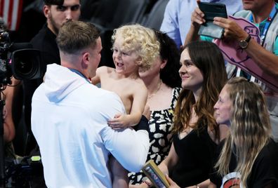 Adam Peaty of Team Great Britain celebrates with his child and girlfriend Holly Ramsay