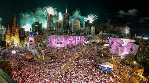 People enjoying the celebrations at Federation Square during the New Year's Eve celebrations on December 31, 2016 in Melbourne.