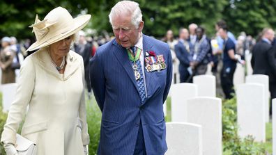 Charles and Camilla walk through the Commonwealth War Graves cemetery as part of D-Day celebrations, Thursday June 6, 2019.