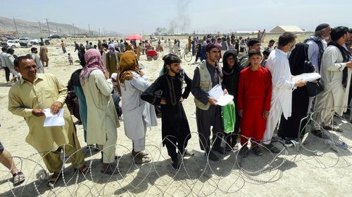 In this August 17  file photo hundreds of people gather outside the international airport in Kabul, Afghanistan. 