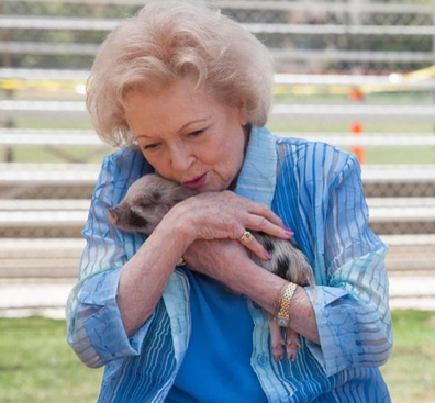 Betty White holding piglet