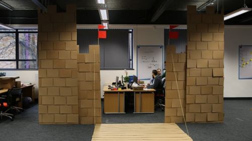 Office workers build huge cardboard castle around desks