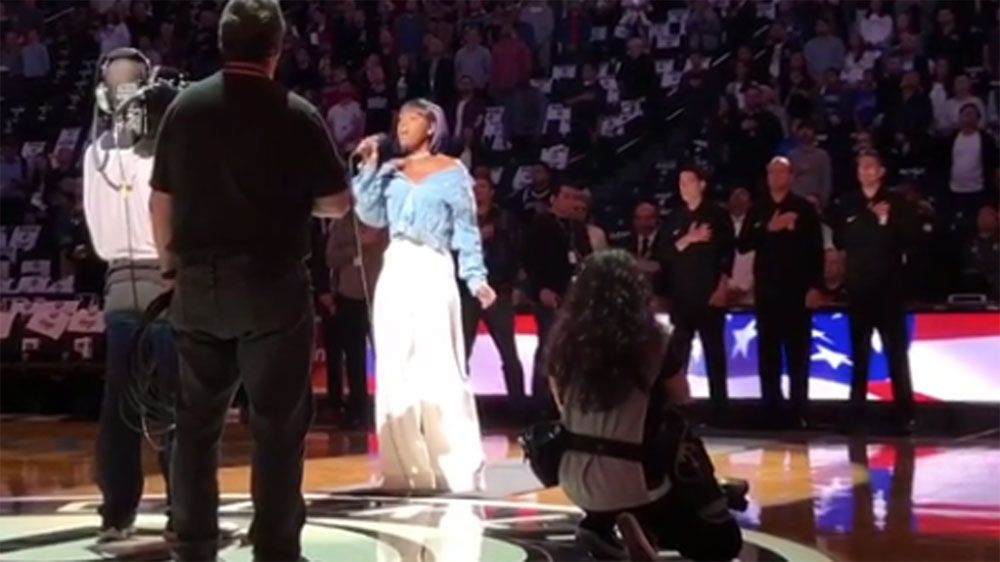 Singer performing US national anthem takes a knee before Brooklyn Nets NBA game