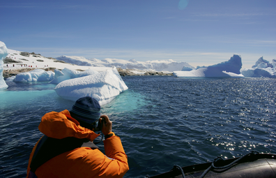 Tourist viewing an iceberg in Antarctica