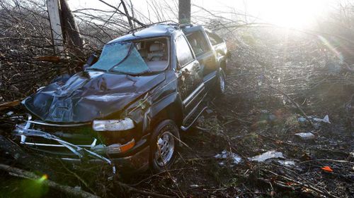 A vehicle sits among debris near the home of Antonio Yzaguirre, 70, and his wife, Ann Yzaguirre, 69, near Linden, Tennessee. (AAP)