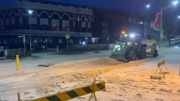 Wild weather dumps two feet of snow-like sand on Sydney suburb