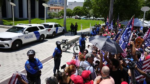 Supporters wait for the arrival of former President Donald Trump at the Wilkie D. Ferguson Jr. U.S. Courthouse, Tuesday, June 13, 2023, in Miami. 