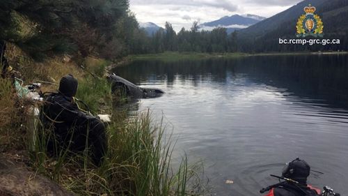 A Canadian dive team watches as Jane Farris' car is hauled from the bottom of Griffin Lake near Revelstoke, British Columbia. Police believe Farris ended up in the lake after swerving to avoid an animal or losing control of the Honda for some other reason.