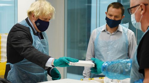 British Prime Minister Boris Johnson is shown the Lighthouse Laboratory used for processing PCR samples, during a visit to the Queen Elizabeth University Hospital campus on January 28, 2021 in Glasgow, United Kingdom