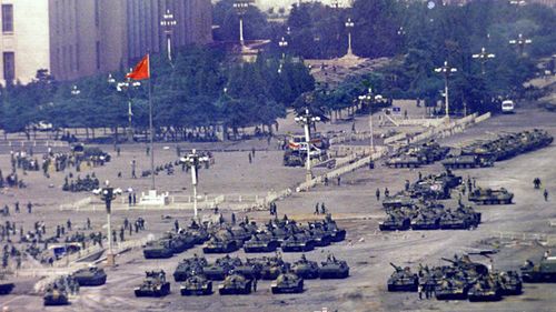 In this June 5, 1989 file photo, Chinese troops and tanks gather in Beijing, one day after the military crackdown that ended a seven week pro-democracy demonstration on Tiananmen Square. Hundreds were killed in the early morning hours of June 4. 