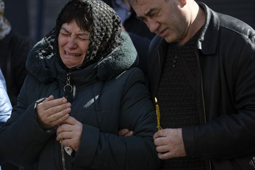 Relatives mourn the dead of Oleksandr Mozheiko, 31, territorial defense soldier who was killed by Russian army on March 5, during his funeral in Irpin, in the outskirts of Kyiv, Ukraine, Friday , April 15, 2022. (AP Photo/Rodrigo Abd)
