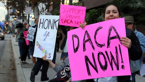 Demonstrators urging the Democratic Party to protect the Deferred Action for Childhood Arrivals Act (DACA) rally outside the office of California Democratic Senator Dianne Feinstein in Los Angeles on January 3, 2018. (AAP)