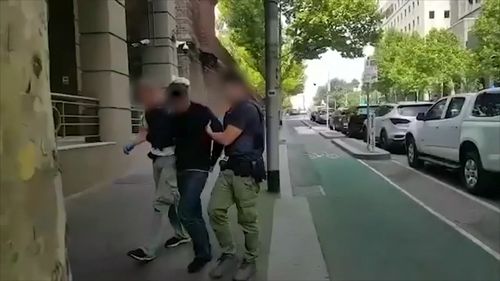A man being led into court following the raids across Melbourne. 