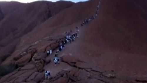 Hundreds queued up to climb Uluru.