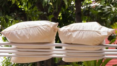 Pillows drying outside on a washing line