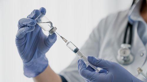 Nurse holding a needle. Injection. Vaccine.