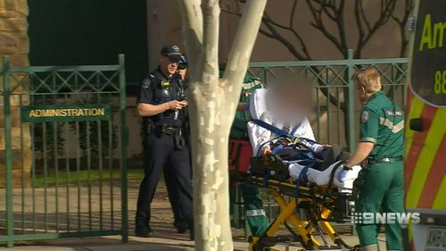 The alleged victim was seen being rushed into an ambulance on a stretcher. Picture: 9NEWS