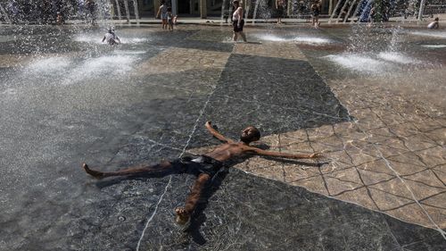 Kais Bothe relaxes in the cool in the city hall pool, as temperatures hit 37 degrees Celsius in Edmonton, Alberta.