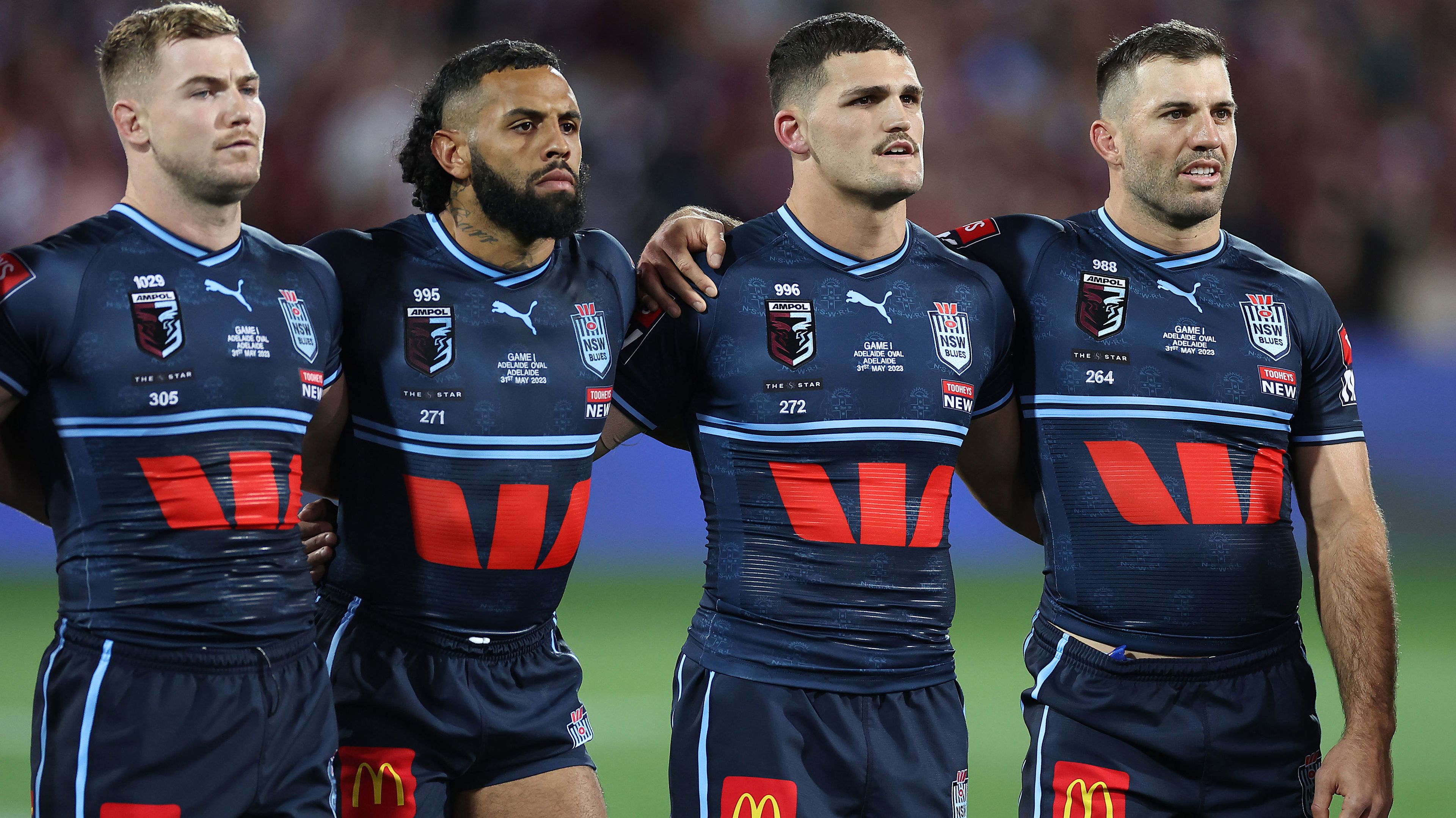 Hudson Young, Josh Addo-Carr, Nathan Cleary and James Tedesco stand together for the national anthem before State of Origin I, 2023.