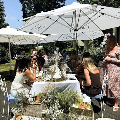 Inside Martha Kalifatidas' baby shower - guests sitting at a table