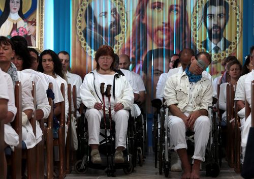 People sit as they prepare to undergo spiritual cures at the Casa de Dom Inacio de Loyola in Abadiania. The Casa de Dom Inacio de Loyola was founded by faith healer Joao Teixeira de Faria in 1978. 