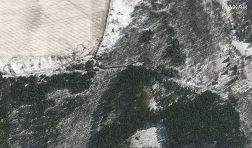 This satellite image provided by Maxar Technologies shows troops and equipment deployed in trees, northwest of Antonov Airport in Lubyanka, Ukraine, during the Russian invasion, Wednesday, March 9, 2022.  