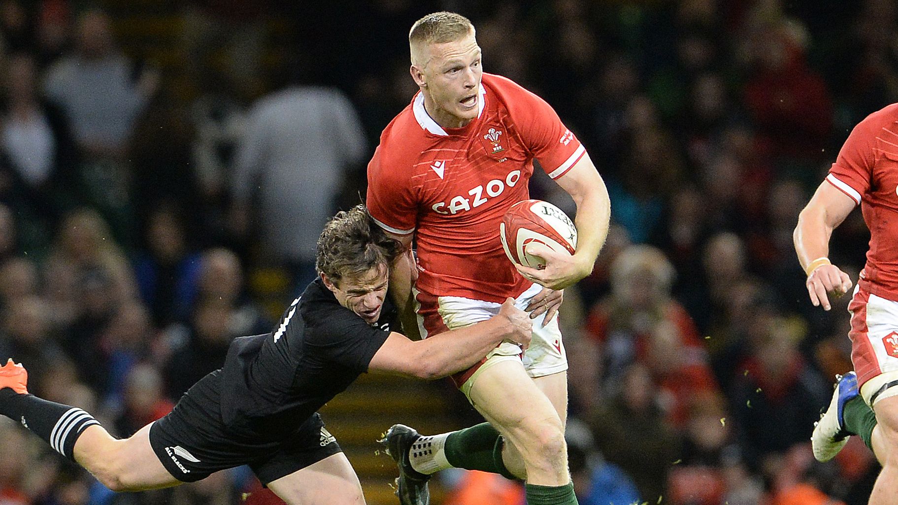 Welsh player Johnny McNicholl is tackled by New Zealand&#x27;s Brad Weber during the Spring Tour in 2021.