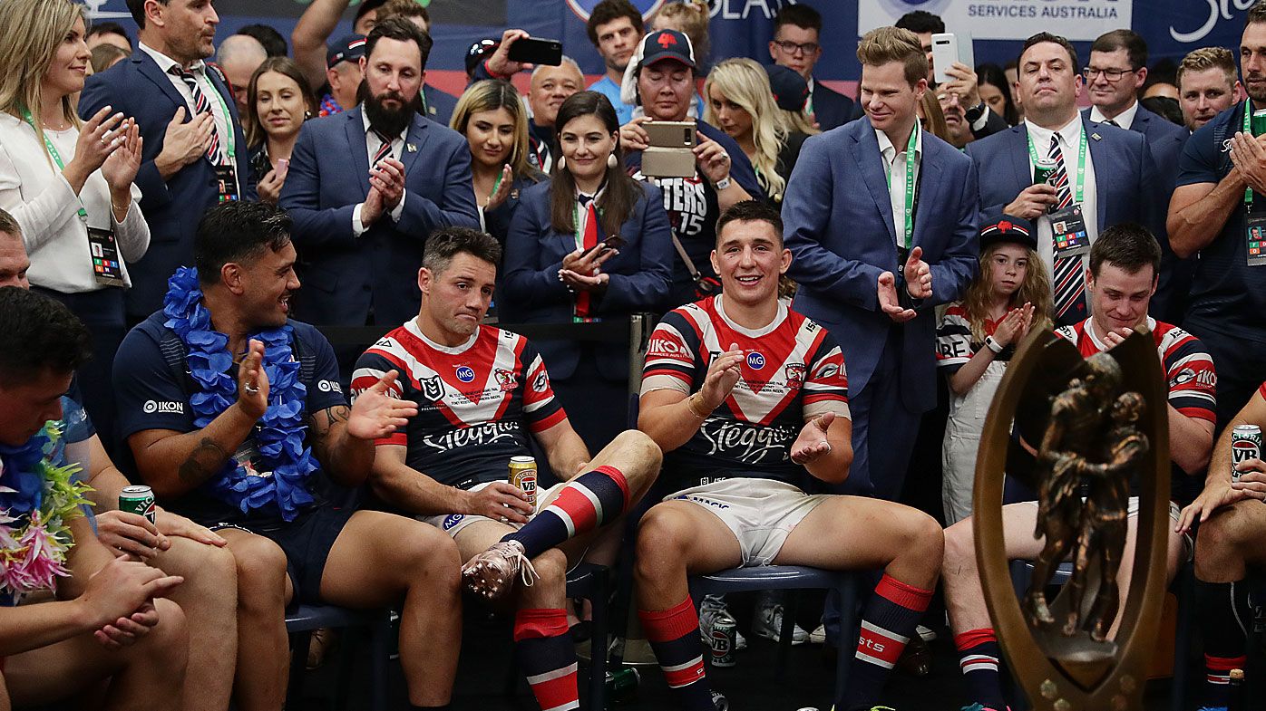 Cooper Cronk is honoured by his teammates in the locker room after the Sydney Roosters won the NRL grand final