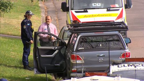 Police inspect a vehicle outside a premises on Ridge Road in Engadine.