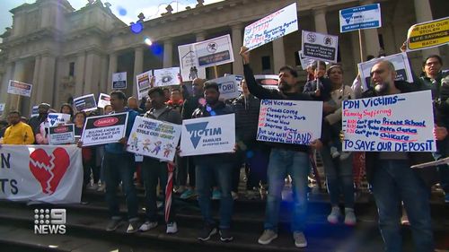 Furious families affected by construction giant Porter Davis' collapse have taken to the steps of the Victorian State Parliament demanding the government pay back tens of thousands of dollars in lost deposits.