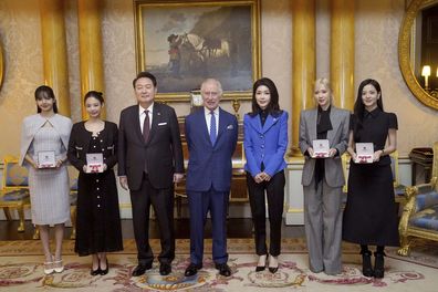 L-R: Lisa (Lalisa Manoban), Jennie Kim, South Korea's President Yoon Suk Yeol, King Charles III, first lady of South Korea Kim Keon Hee, Rose (Roseanne Park), and Jisoo Kim pose for a photo following a special investiture ceremony to present the members of the K-Pop band Blackpink with Honorary MBEs, Member of the Order of the British Empire, at Buckingham Palace, in London, Wednesday, Nov. 22, 2023