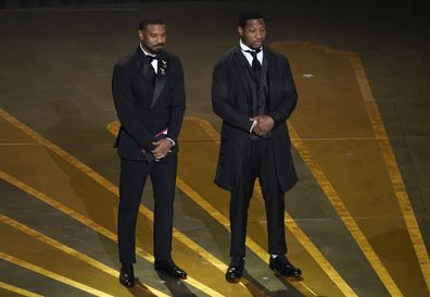 Michael B. Jordan, left, and Jonathan Majors present the award for best cinematography at the Oscars on Sunday, March 12, 2023, at the Dolby Theatre in Los Angeles. (AP Photo/Chris Pizzello)