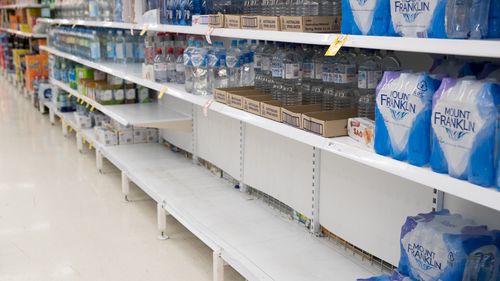 Empty shelves where boxes of water would normally be, in Coles Supermarket, Woy Woy. 