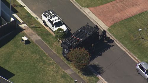 An armoured vehicle is stationed out the front of a home in Sydney's south-west.