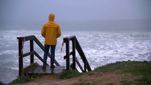 A person looks out to sea at Collaroy beach, in Sydney's north.