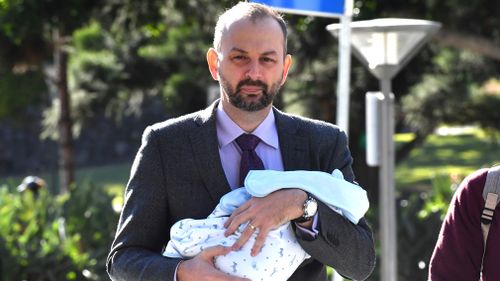 Sean Black arrived at court today holding a baby. Picture: AAP
