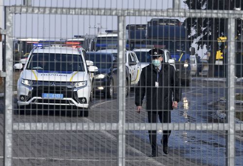 A motorcade with police cars and busses with passengers from the Ukrainian aircraft chartered by the Ukrainian government for evacuation from the Chinese city of Wuhan, leave the the gate upon their landing at airport outside Kharkiv.